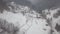 Calm and cosy fairy-tale village Kryvorivnia covered with snow in the Carpathians mountains, aerial view