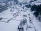 Calm and cosy fairy-tale village Kryvorivnia covered with snow in the Carpathians mountains, aerial view. Typical landscape in