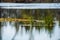 calm countryside lake river with cloud reflections in water and green shores