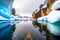 calm drifting on water among ice of snow and rocks winter kayaking in antarctica
