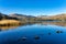 A calm Elterwater with the Langdale Pikes in the distance