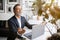 Calm european senior businessman in suit sits at table with computer with closed eyes, meditates