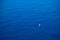 Calm flat surface of ocean and small fisher boat. Mediterranean Sea.