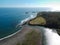 Calm foamy waves crashing on a beach on a sunny day