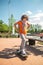 Calm focused adolescent getting on the skateboard