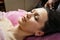 Calm girl having spa facial massage in luxurious beauty salon