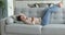 Calm Indian woman enjoy relaxation lying on sofa at home