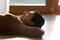 Calm Indian woman relax on floor at home napping