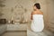 Calm lady wearing white towel while sitting in the Turkish bath