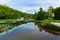 Calm lake with water lilies and chalets around