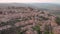 Calm landscape of small italian hill town and comune Montalcino from drone in summer day, camera is flying slowly