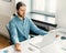 Calm male office worker meditating with closed eyes at work