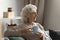 Calm mature woman dreaming of future with cup of tea.