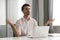 Calm mindful businessman taking break meditate sit at office desk