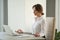 Calm mindful businesswoman meditating at office desk with eyes c