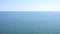 Calm ocean background. Blue water with small waves and clear sky. 4K