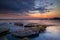 Calm ocean long exposure. Stones in mysterious mist of the sea waves. Concept of nature background. Sunset scenery background.