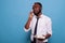 Calm office worker holding cord telephone in hand focusing to listen