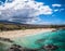 Calm Pacific Ocean and sunny, cloudy shore in Hawaii, USA