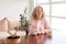 Calm and peaceful middle-aged gray-haired woman takes a break at home