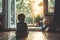 Calm and peaceful moments in a household with young child sitting on the floor in front of the window