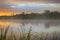 Calm, pleasant warm summer rain and mist over river