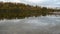 Calm reflective river water surface with mighty forest