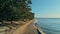 Calm and relaxing aerial drone image of a stunning beautiful hidden remote ocean sea shore at sunset with an endless sandy beach