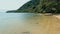 Calm and relaxing aerial drone image of a stunning beautiful hidden remote ocean sea shore at sunset with an endless sandy beach