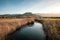 Calm river passing between rushes at Lozari in Corsica