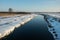 Calm river and snow in the meadows