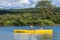 Calm River and Woman relaxing in a Kayak