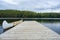 Calm Scene of a Canoe Parked Beside a Dock in a Lake #2