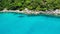 Calm sea near tropical volcanic island. Drone view of peaceful water of blue sea near stony shore and green jungle of volcanic Koh