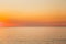 Calm Sea Or Ocean And Yellow Clear Sunset Or Sunrise Sky Background