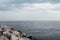 Calm sea with rocks on the shore. Cloudy sky and calm sea. Photo of an amazing nature