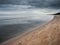 Calm sea scape, Blue water and cloudy sky, yellow sandy beach, Jurmala region, Latvia