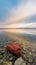 Calm sea with transparent water by wonderful sunrise, vivid red