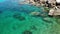 Calm sea water near stones. Peaceful blue sea water and gray boulders in perfect place for snorkeling on Koh Tao Island on sunny