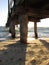 Calm sea waves under a wooden plank jetty in Seaford, VIC, Australia