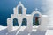 Calm sea, white church arch, bells Santorini