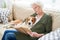 Calm senior woman with Beagle at home