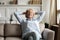 Calm senior woman relax on couch in living room