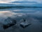 Calm, serenity, meditation concept. Sunset on the lake, stones in the water in the foreground, quiet water, cloudless sky