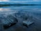 Calm, serenity, meditation concept. Sunset on the lake, stones in the water in the foreground, quiet water, cloudless sky