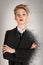 Calm and serious blond business woman in black suit with dispersion effect