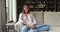 Calm smiling young lady homeowner posing for portrait on couch