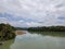 Calm still water river and cloudy sky