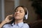 Calm teen female in cordless headset listen to tranquil melody