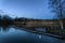 Calm tranquil moonlit landscape over lake and jetty